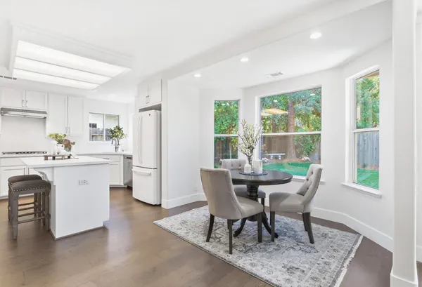 a view of a dining room with furniture window and wooden floor
