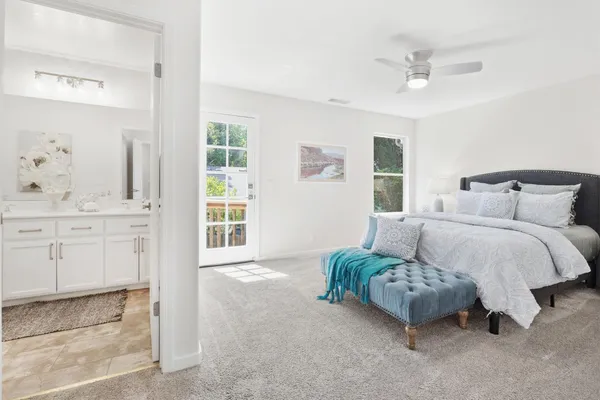 a bedroom with a bed mirror and window