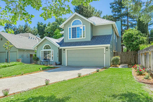 a front view of a house with a yard and garage