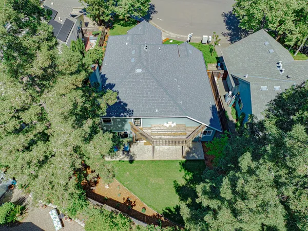 an aerial view of a house with a yard
