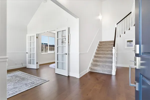 a view of entryway with wooden floor and stairs