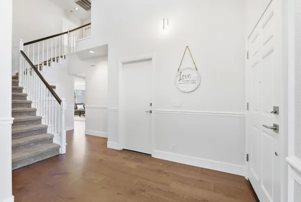 a view of a room with wooden floor and white walls