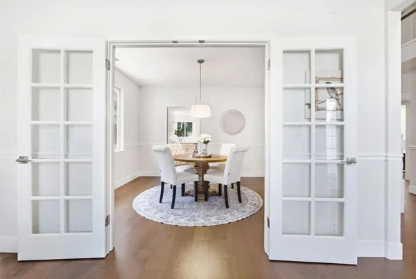 a view of a dining room with furniture and wooden floor