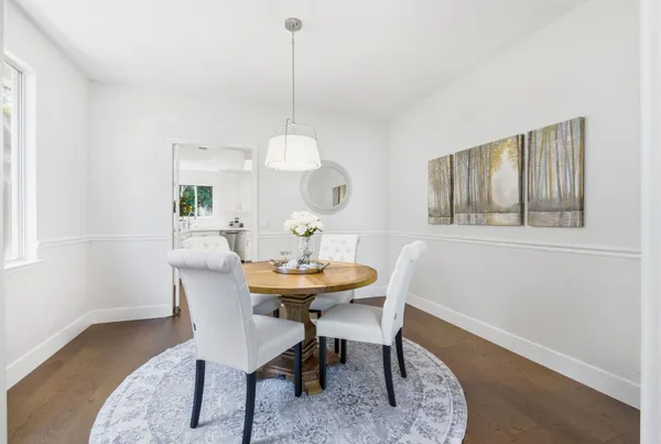 a view of a dining room with furniture window and wooden floor