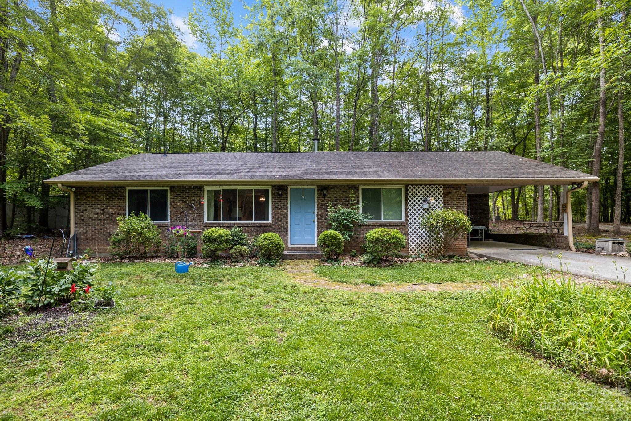 6906 Newman Road Waxhaw, NC 28173 - Photo 1 of 23 a front view of a house with a yard table and chairs