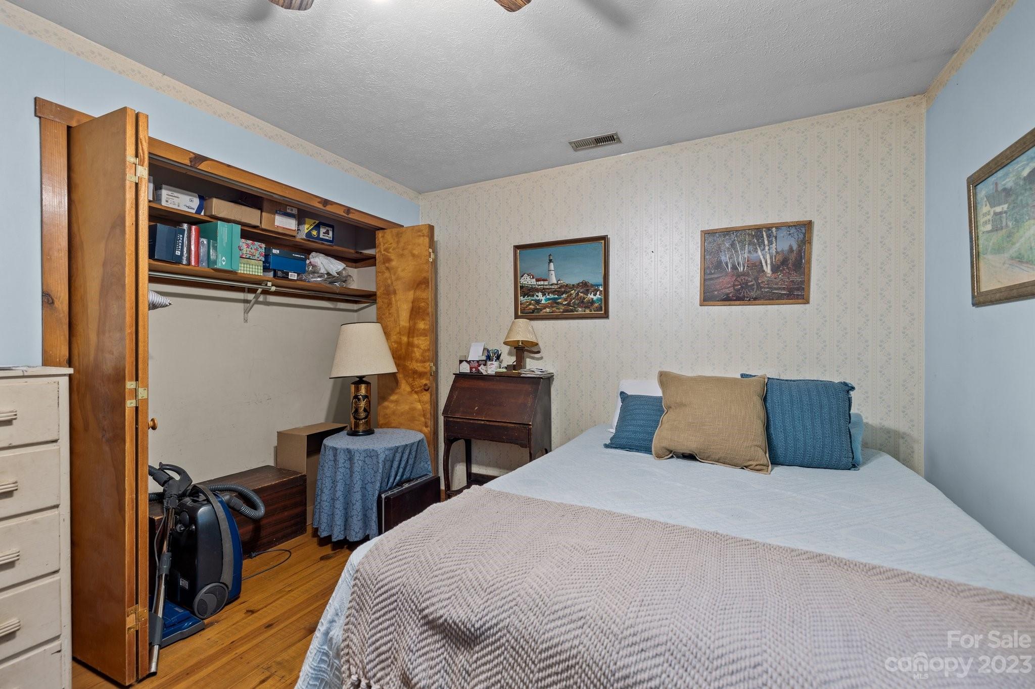 6906 Newman Road Waxhaw, NC 28173 - Photo 17 of 23 a bedroom with a bed and wooden floor