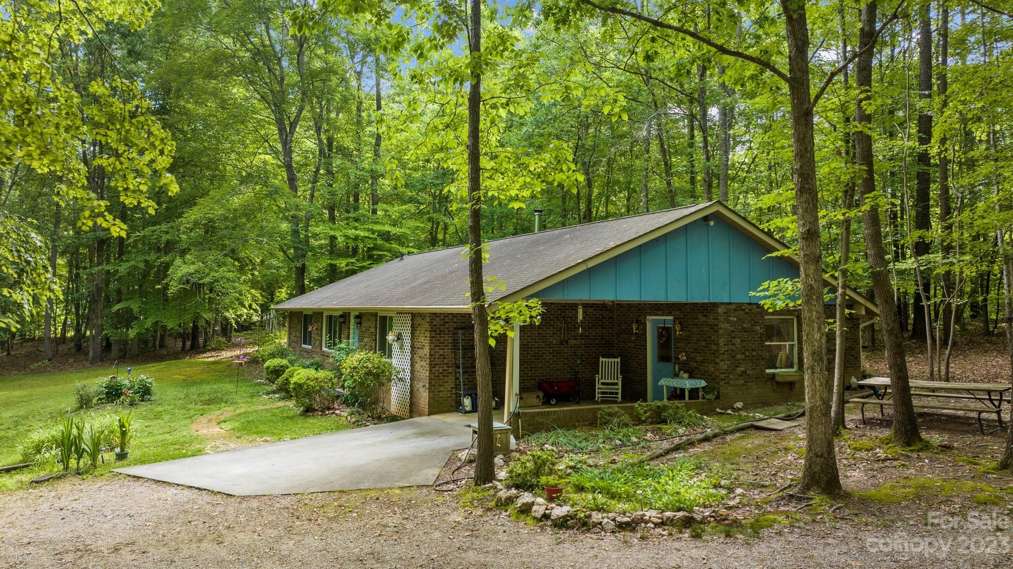 6906 Newman Road Waxhaw, NC 28173 - Photo 3 of 23 a backyard of a house with garden and outdoor seating