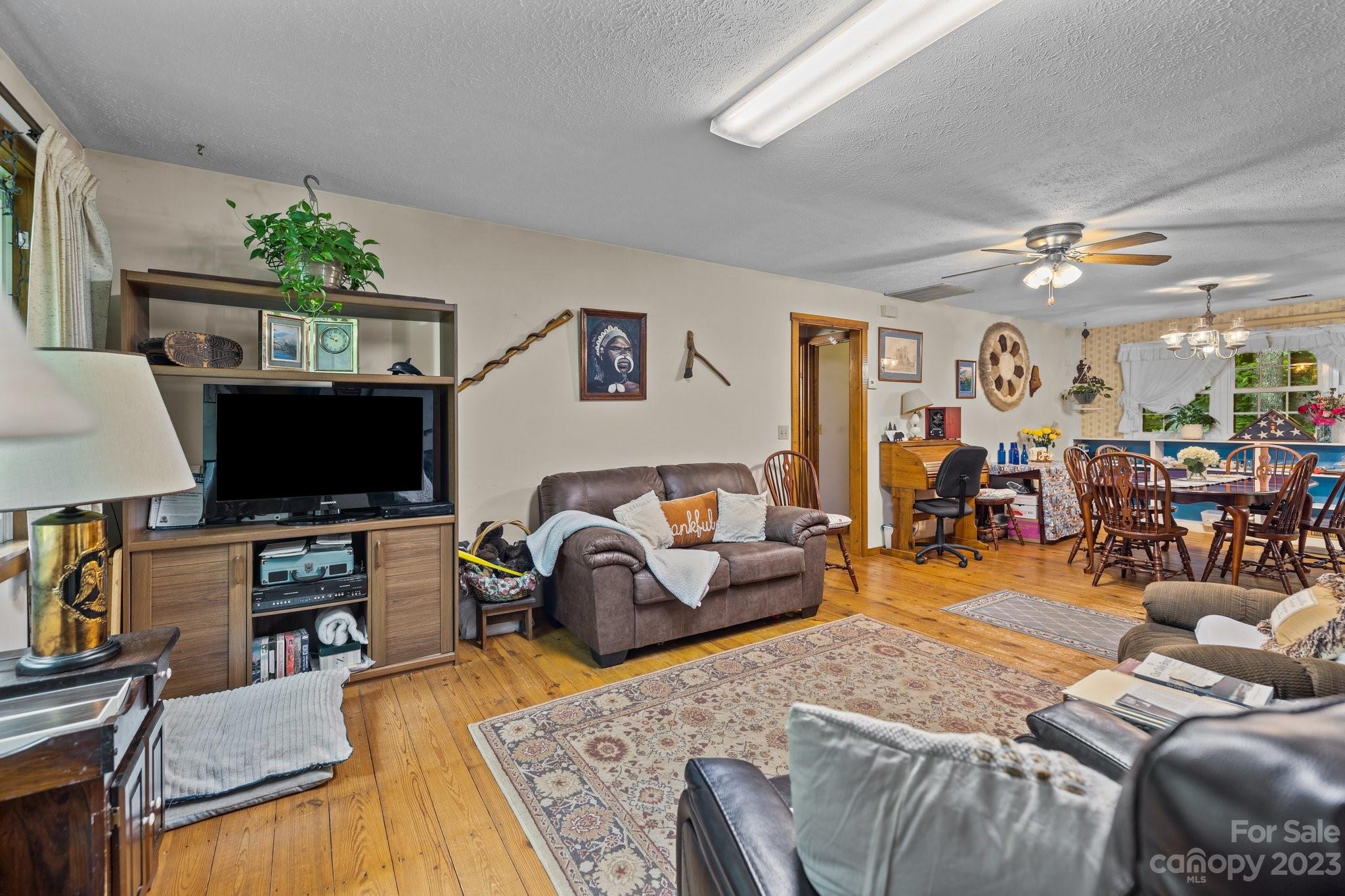 6906 Newman Road Waxhaw, NC 28173 - Photo 7 of 23 a living room with furniture and a flat screen tv