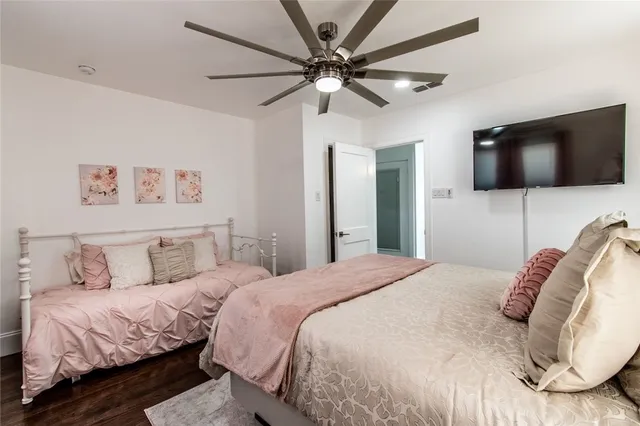 a bedroom with a bed and a flat screen tv