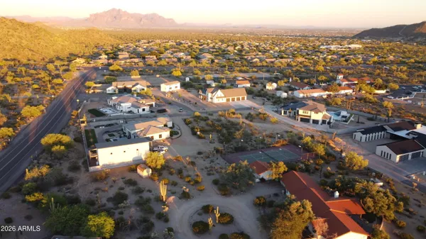 an aerial view of a house with a yard and sitting area