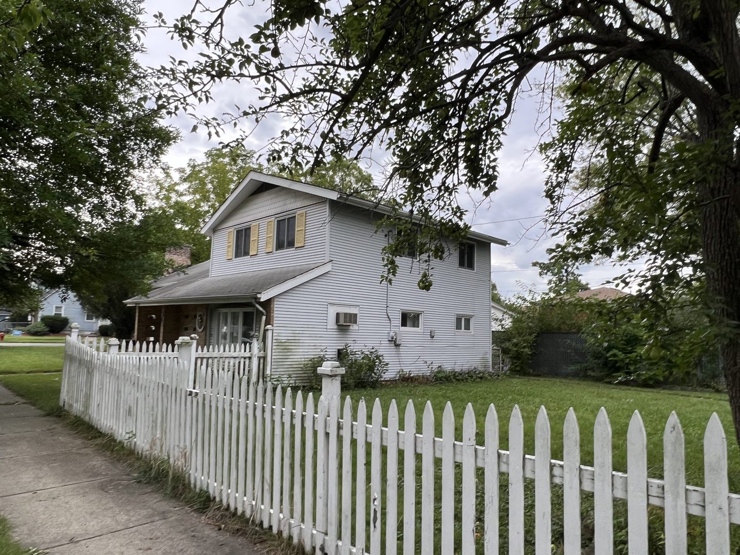 3454 Monroe Street Lansing, IL 60438 - Photo 1 of 4 a front view of a house with wooden fence