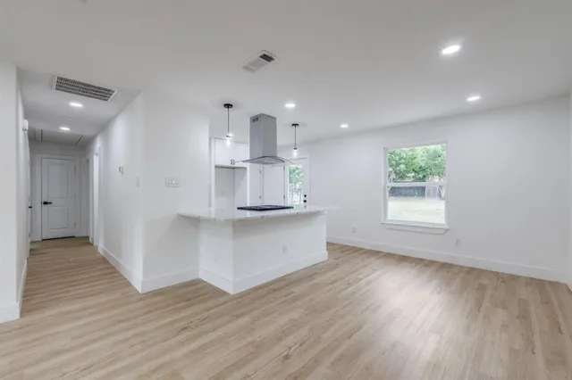 a view of kitchen with wooden floor and electronic appliances