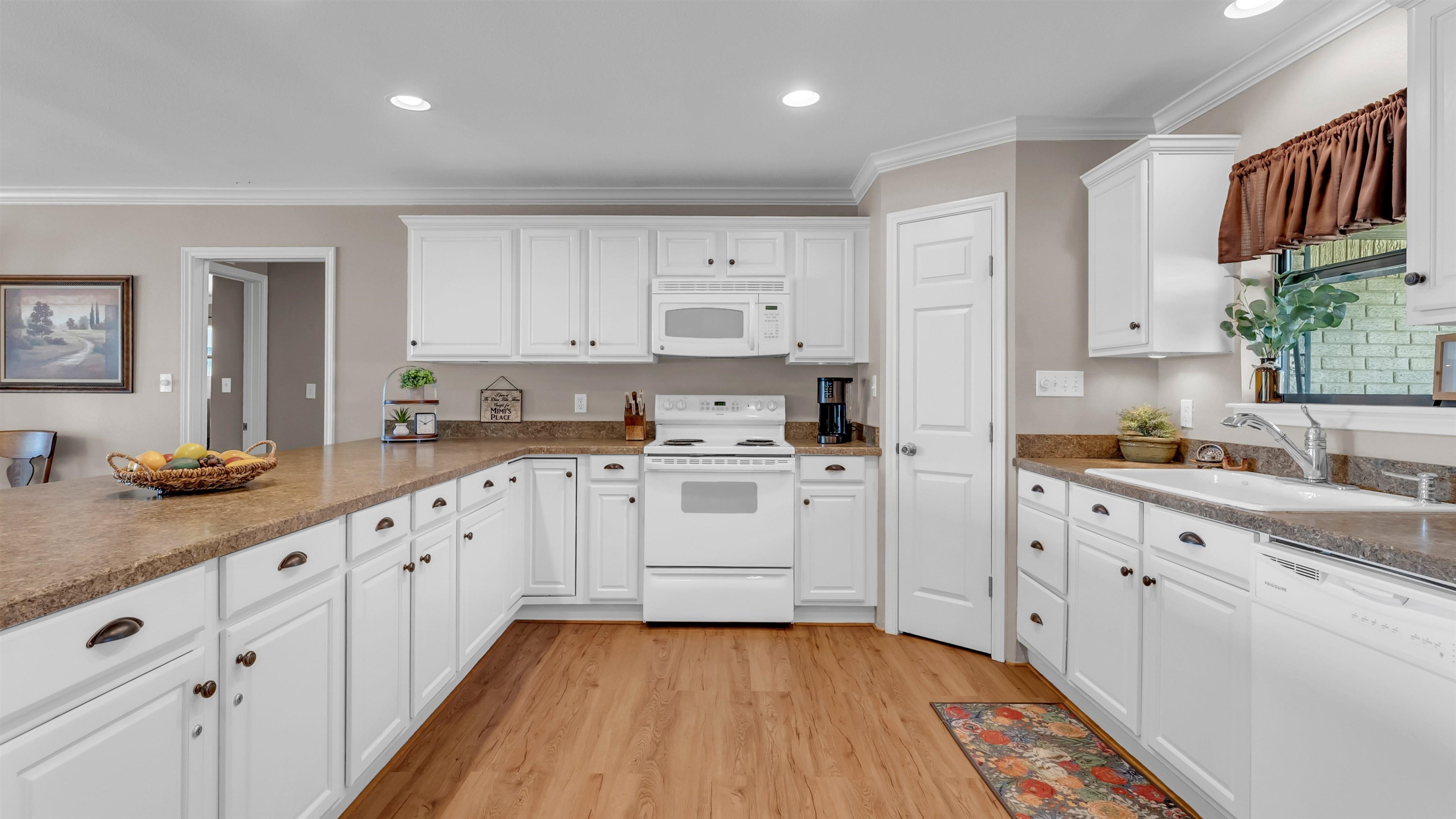 539 Ellen Williams Loop Kingsland, TX 78639 - Photo 12 of 30 a kitchen with granite countertop white cabinets and white appliances