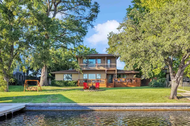 a front view of a house with a yard table and chairs