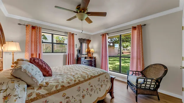 a bedroom with a bed chair and a window