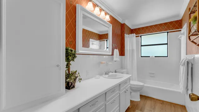 a bathroom with a tub a sink and mirror