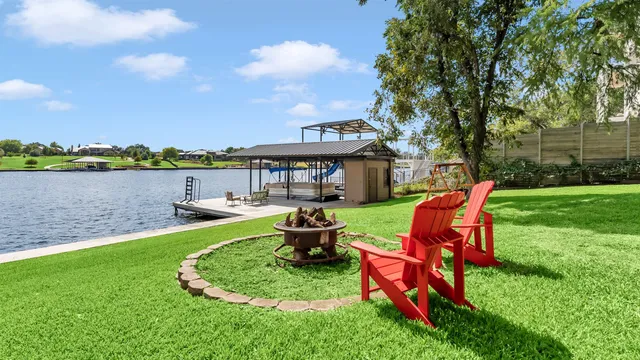 a view of a lake with couches chairs