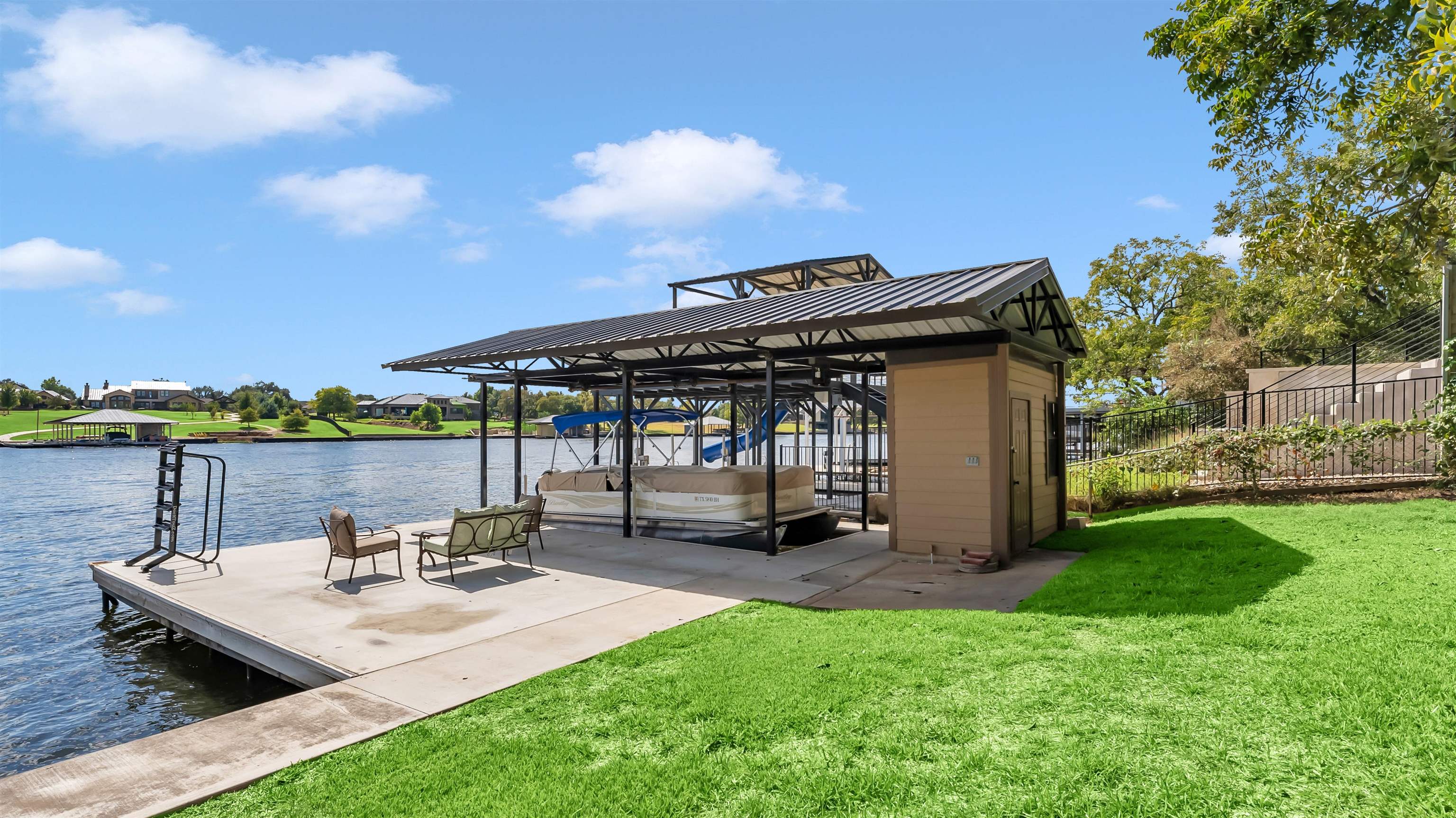 539 Ellen Williams Loop Kingsland, TX 78639 - Photo 29 of 30 a view of a patio with table and chairs under an umbrella with wooden floor and fence