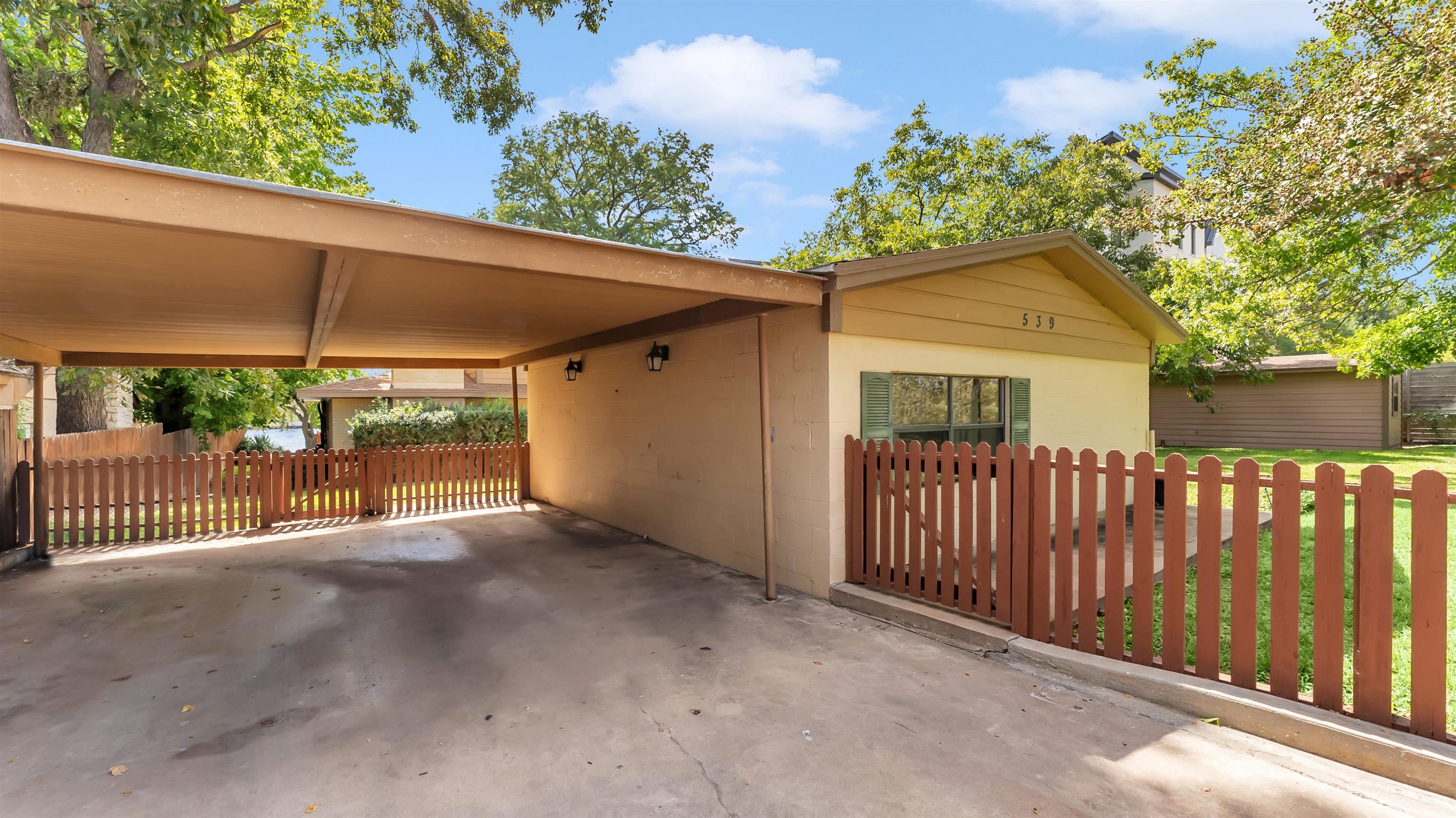 539 Ellen Williams Loop Kingsland, TX 78639 - Photo 6 of 30 a view of a patio with a table and chairs under an umbrella