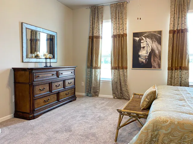 a bedroom with a bed and a mirror