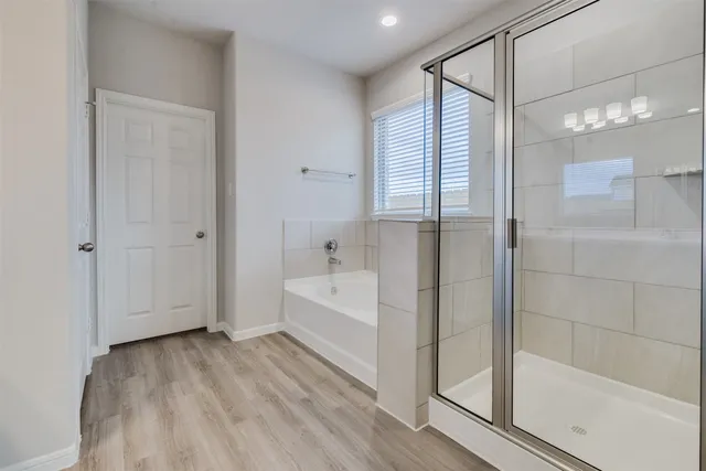 a bathroom with a bathtub and a shower