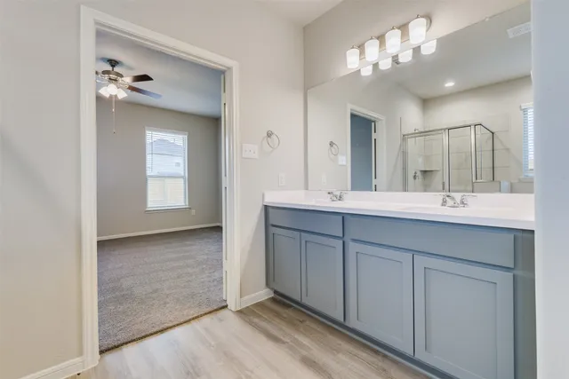 a bathroom with a double vanity sink and a mirror