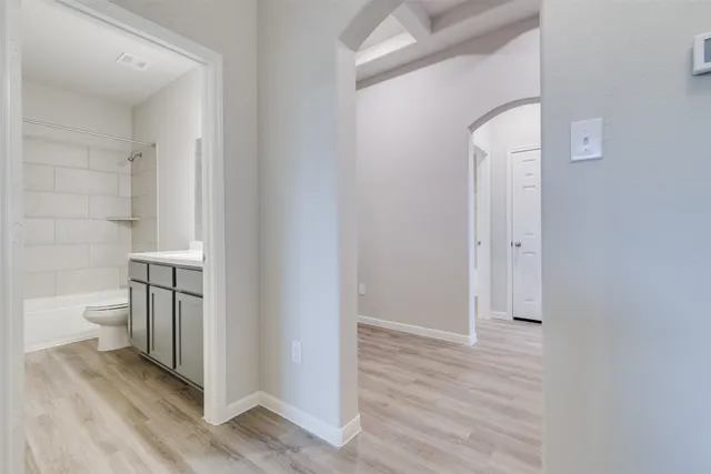 a bathroom with a granite countertop toilet and a sink