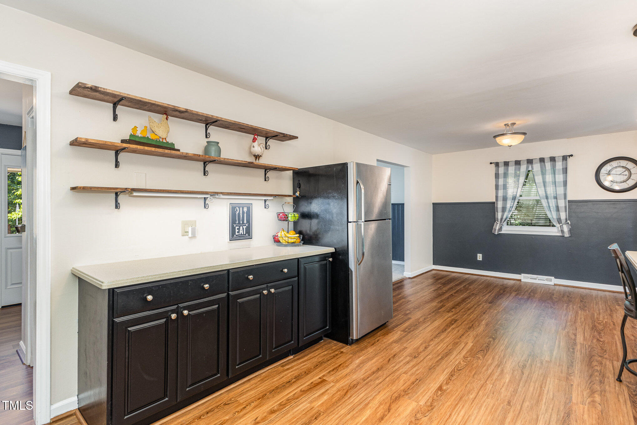6609 Electra Drive Raleigh, NC 27607 - Photo 13 of 35 a kitchen with stainless steel appliances wooden floor sink and wooden cabinets