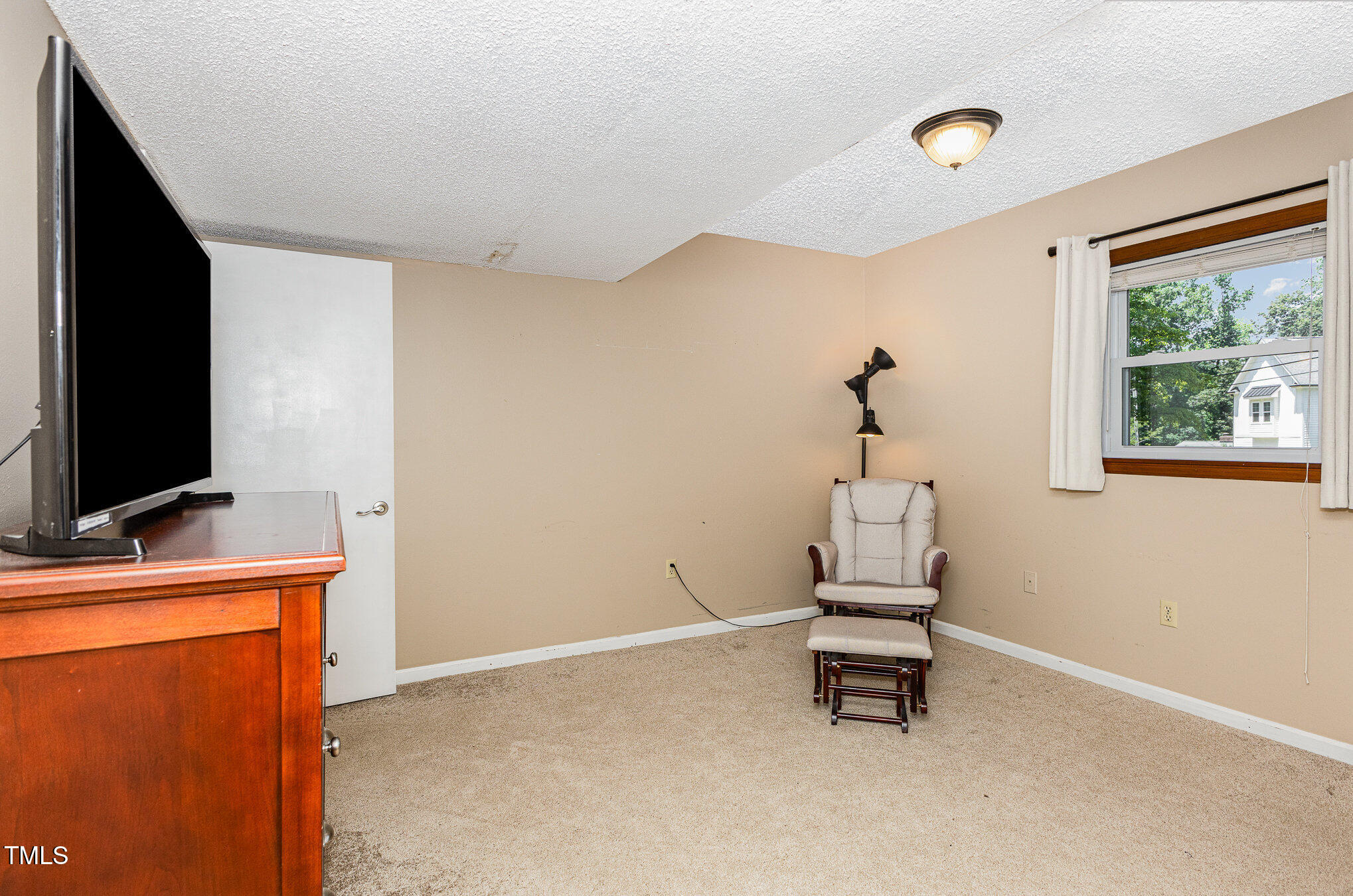 6609 Electra Drive Raleigh, NC 27607 - Photo 19 of 35 a room with a window and a flat screen tv