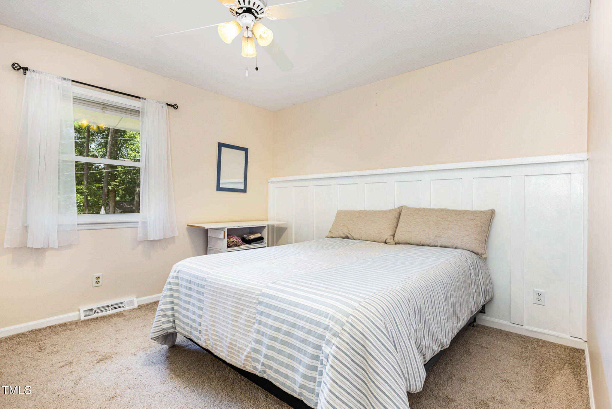 6609 Electra Drive Raleigh, NC 27607 - Photo 24 of 35 a bedroom with a large bed and a chandelier