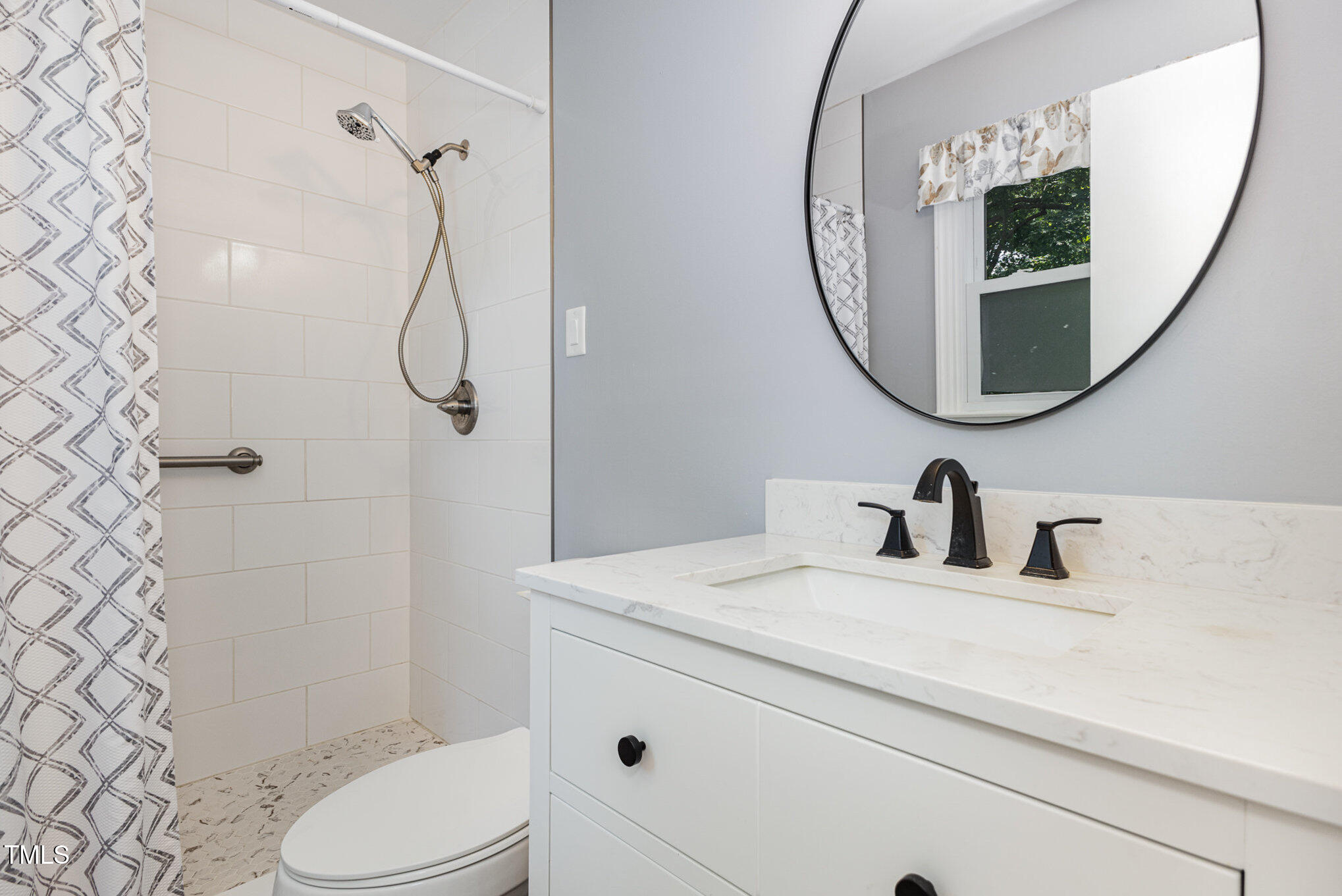 6609 Electra Drive Raleigh, NC 27607 - Photo 28 of 35 a bathroom with a sink a toilet and a mirror