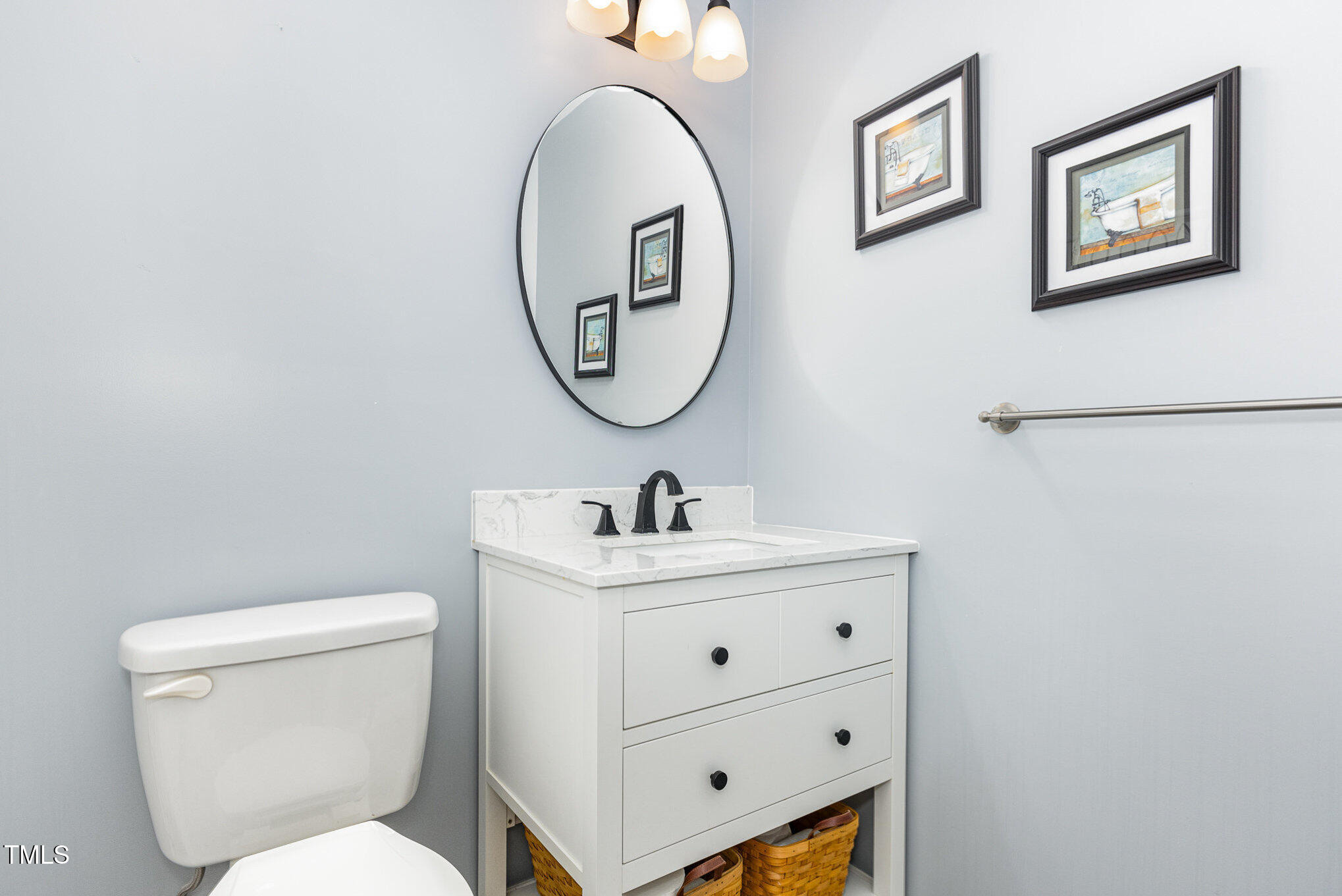 6609 Electra Drive Raleigh, NC 27607 - Photo 29 of 35 a bathroom with a toilet a sink and a mirror