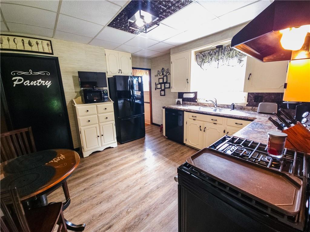 496 Great Belt Road Butler, PA 16002 - Photo 2 of 33 a kitchen with stainless steel appliances granite countertop a stove a refrigerator a sink dishwasher and cabinets with wooden floor