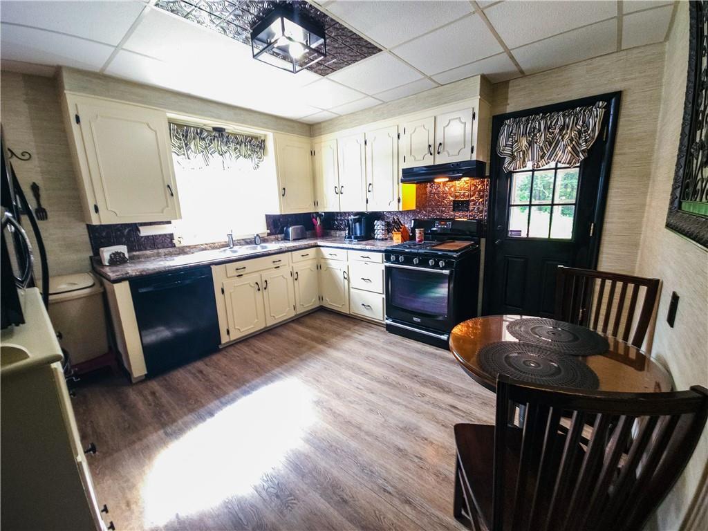496 Great Belt Road Butler, PA 16002 - Photo 4 of 33 a kitchen with wooden floors and wooden cabinets