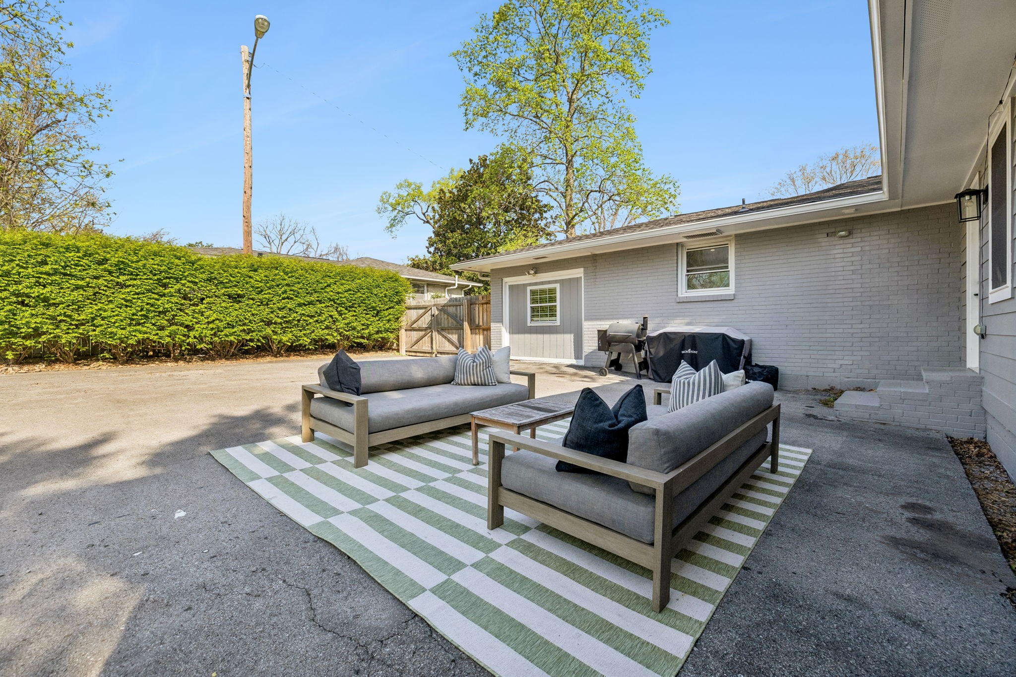 383 Blackman Road Nashville, TN 37211 - Photo 48 of 71 a view of a patio with couches and a table and chairs with wooden floor
