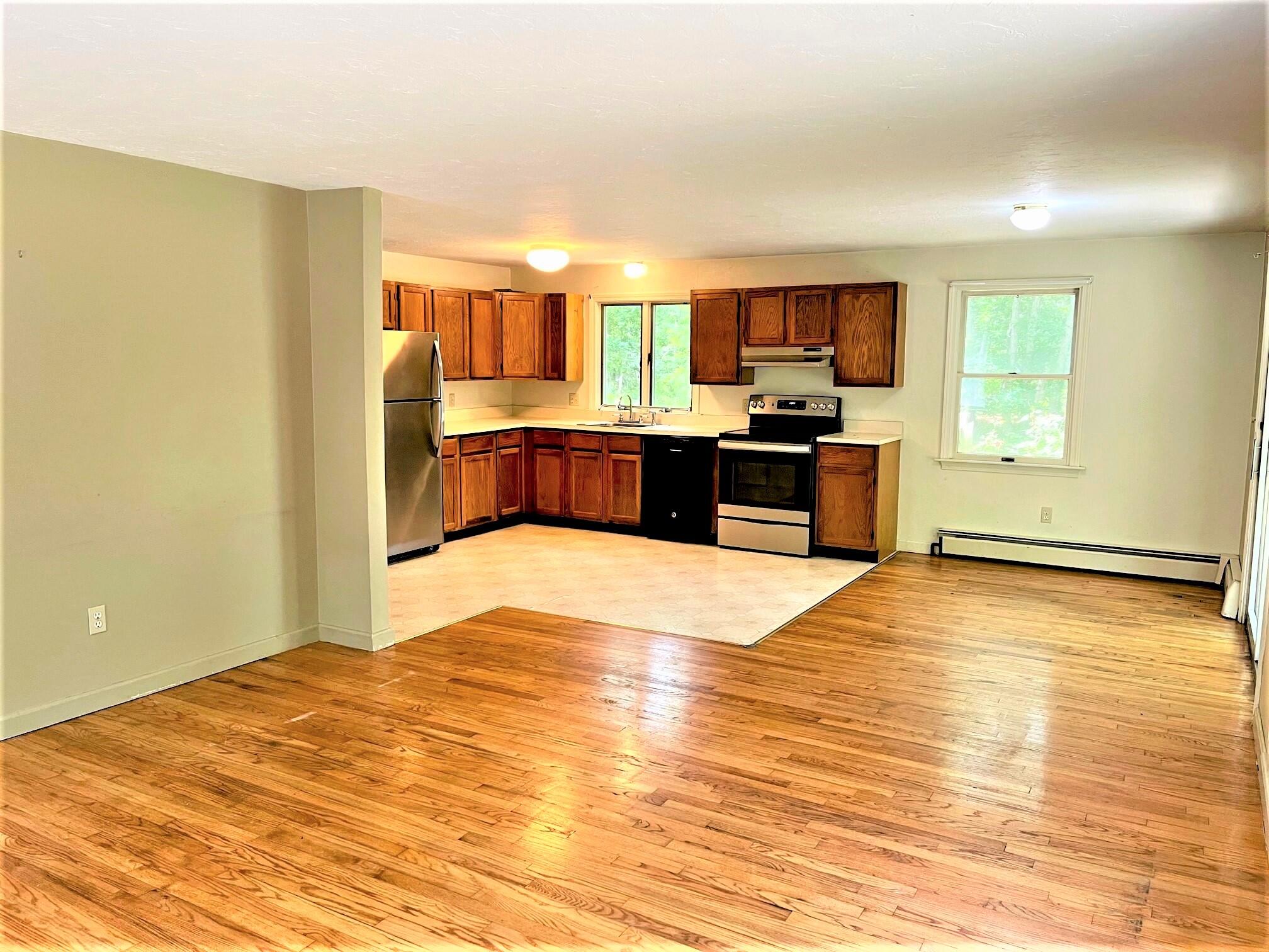 8 Boylston Drive Edgartown, MA 02539 - Photo 3 of 17 a view of a kitchen with kitchen island a sink wooden floor and a counter top space