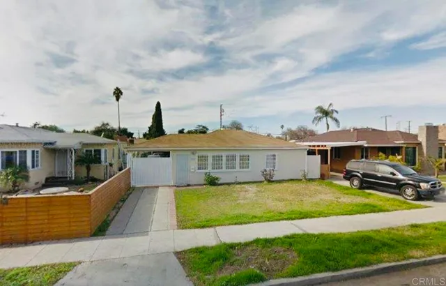 a view of a house with a big yard and potted plants