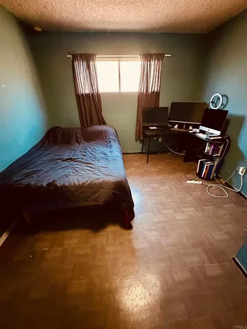 a bedroom with a bed window and dresser