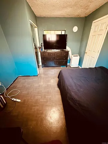 a bedroom with a bed and a flat screen tv