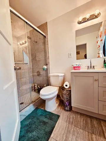 a bathroom with a toilet a sink and a mirror