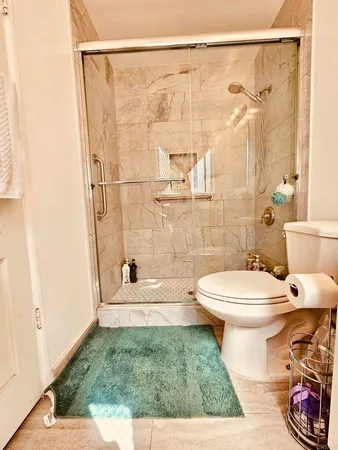 a bathroom with a toilet and a shower