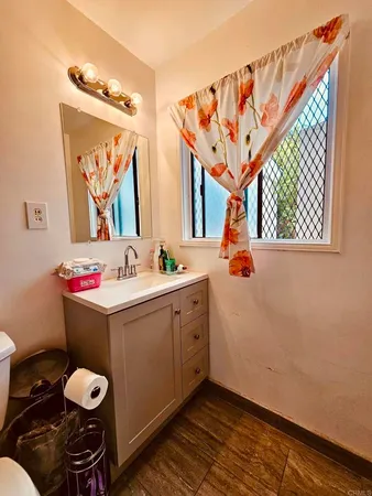 a bathroom with a sink vanity and mirror