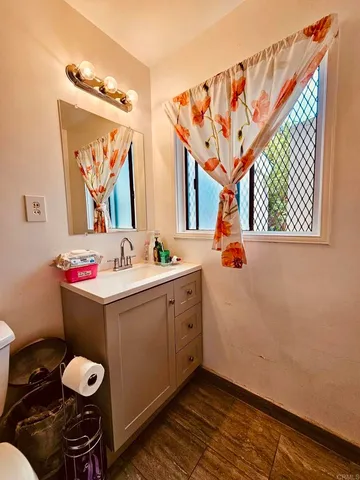 a bathroom with a sink vanity and mirror