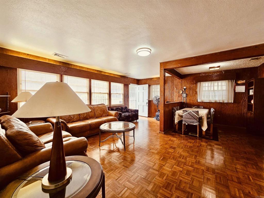 3333 Delta Avenue Long Beach, CA 90810 - Photo 3 of 31 a living room with furniture a rug and a floor to ceiling window