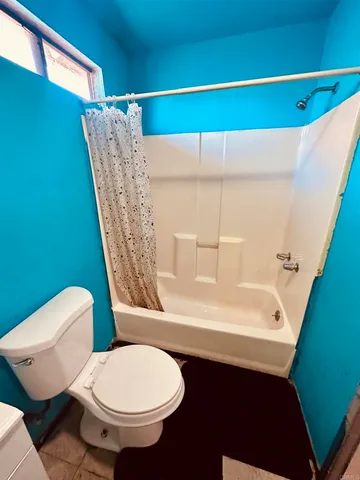 a bathroom with a sink a toilet a mirror and shower