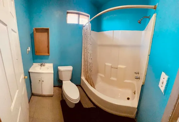 a bathroom with a toilet and a mirror