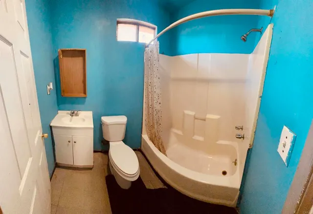 a bathroom with a toilet and a mirror