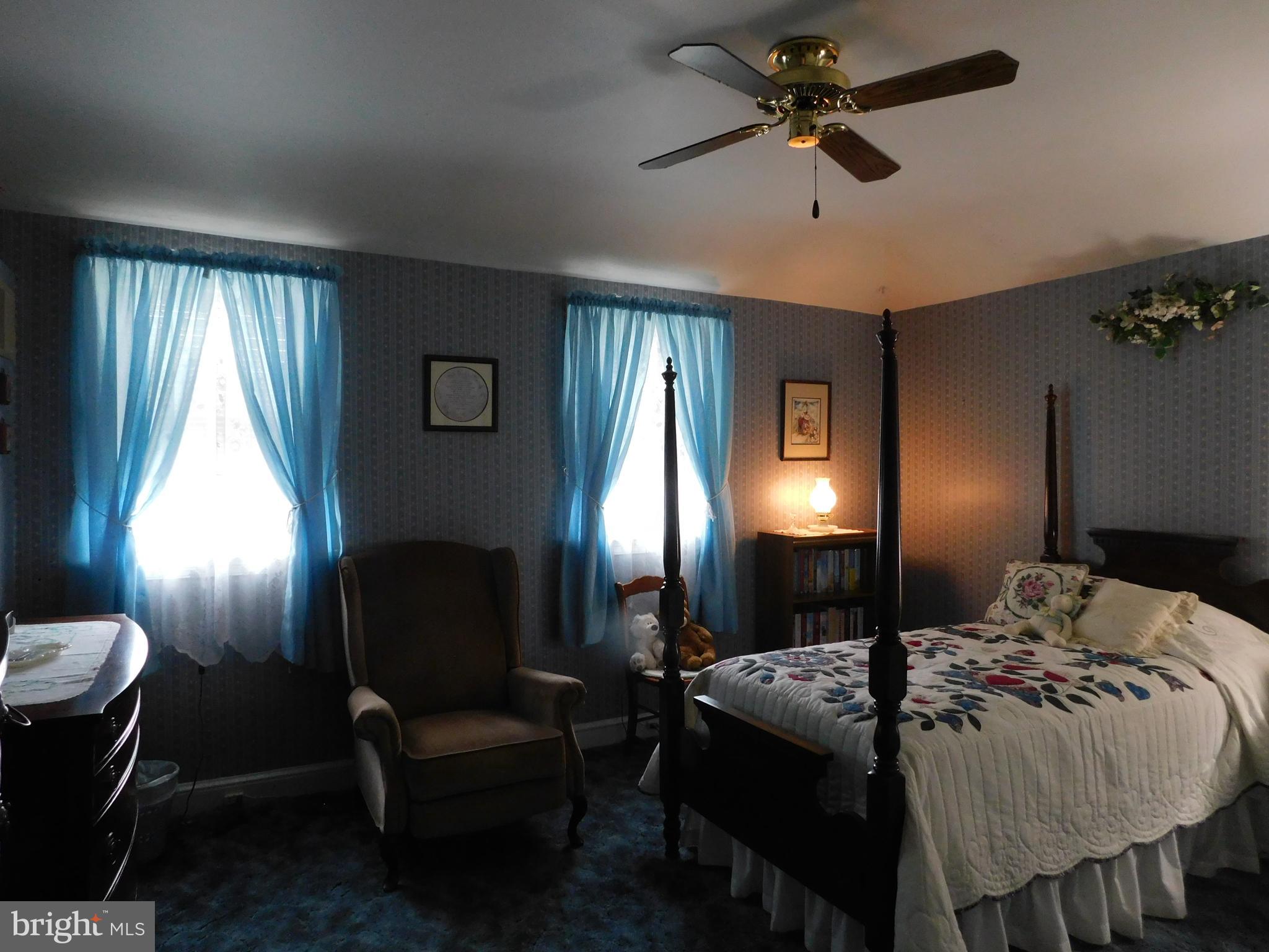 8504 Oakleigh Road Baltimore, MD 21234 - Photo 11 of 35 a bedroom with a bed and a chandelier