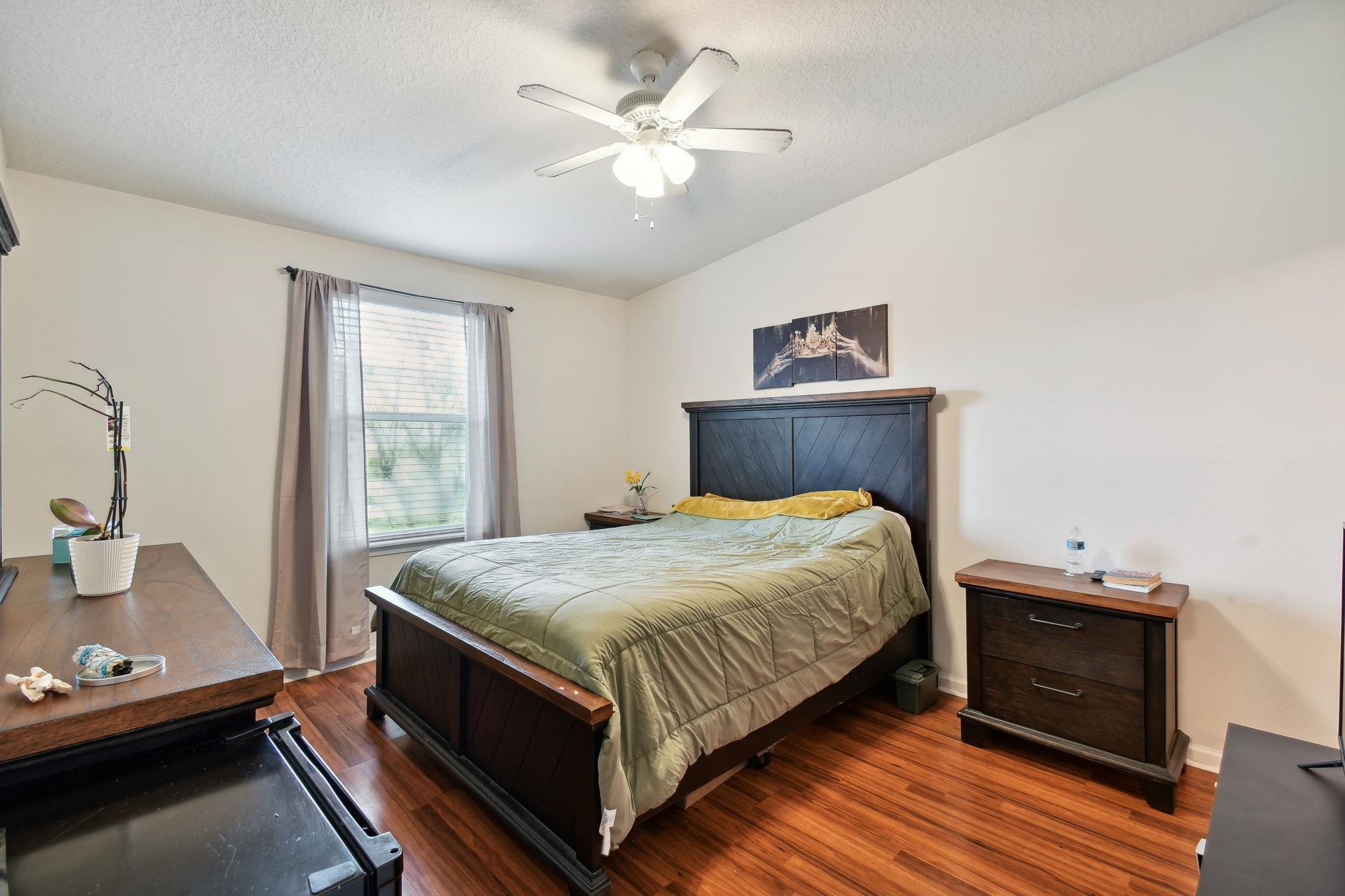 2481 Golden Lake Loop St. Augustine, FL 32084 - Photo 12 of 39 a bedroom with a bed and a ceiling fan