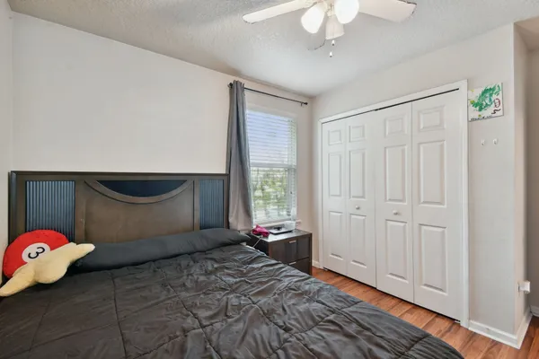 a bedroom with a bed and a chandelier